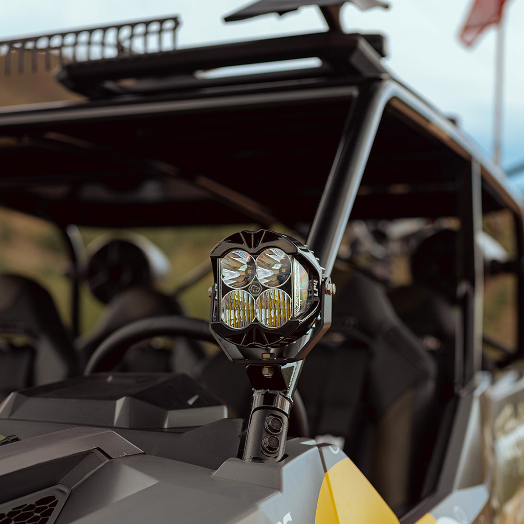 Baja Designs LP4 Pro LED driving light in amber combo beam, angled side view showing housing and lens detail