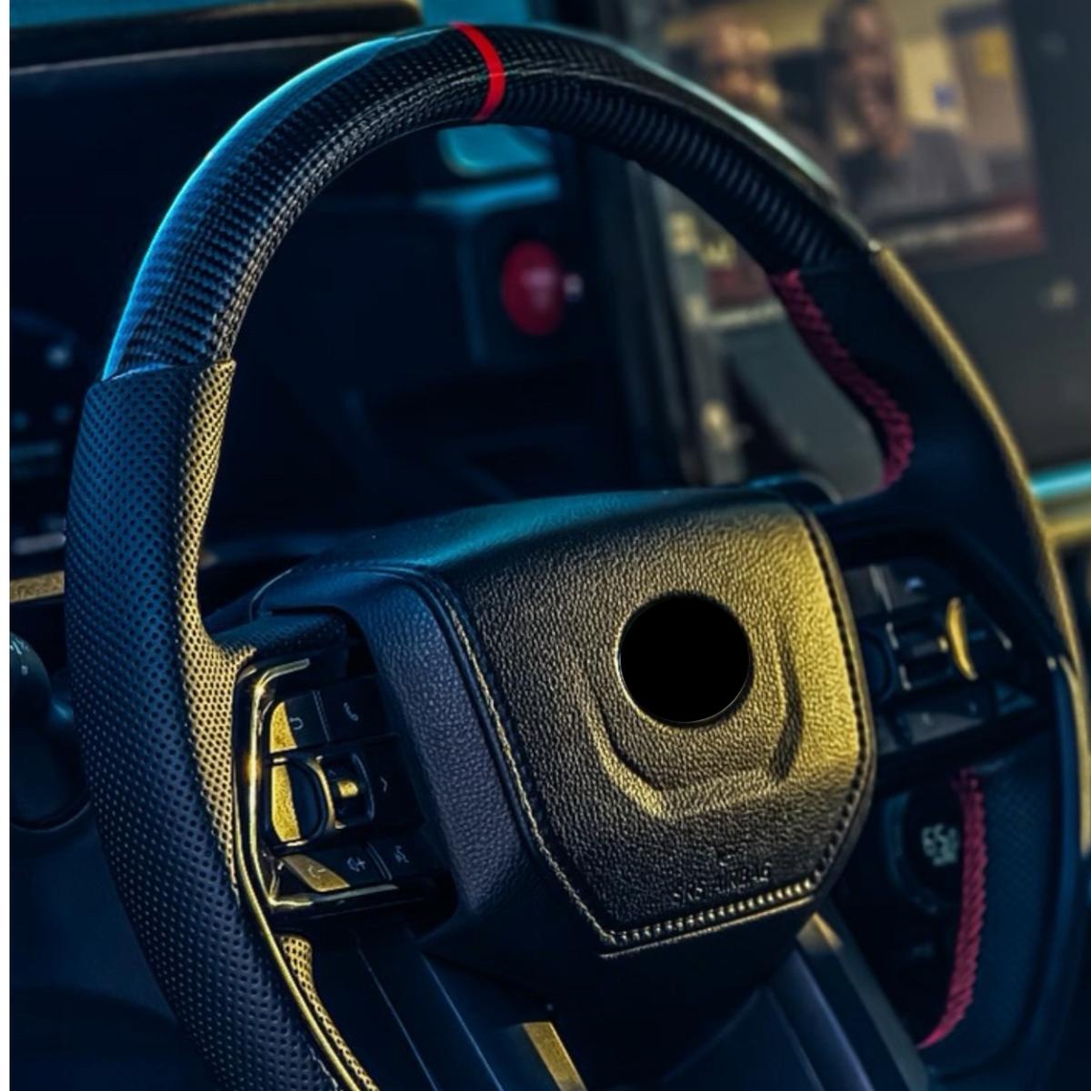 Aspire Auto Accessories carbon fiber steering wheel showing stitched leather grip and spoke detail